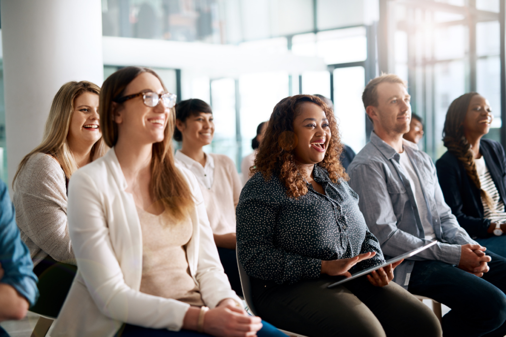 Employees happily sitting in a meeting