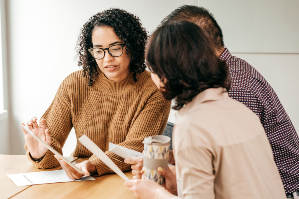 woman teaching another woman and man